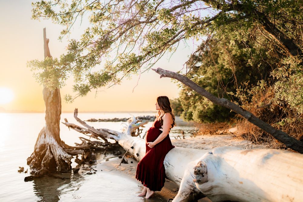 Ethereal sunset wedding photography session features a couple in romance poses on a beach with dramatic lighting effects.