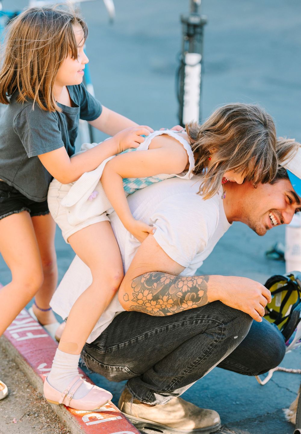 Playful piggyback ride moment captured near waterfront.