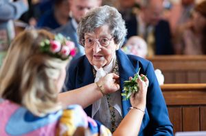 A series of candid reception photos showing guests enjoying themselves at a wedding celebration in a wood-paneled venue.