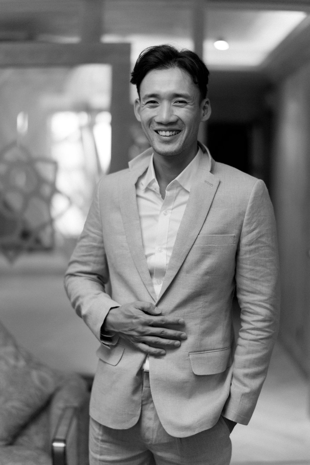 Professional portraits taken in a modern indoor setting showing expressions of joy.