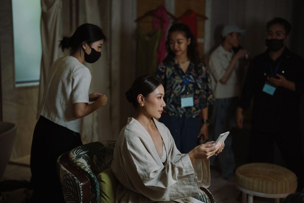 Dimly lit indoor wedding preparation scene with elegant decor.