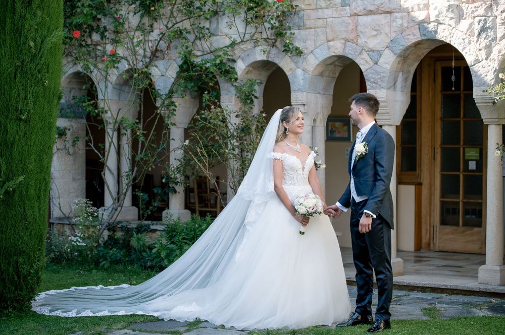 Wedding photography in courtyard featuring stone architecture and greenery.