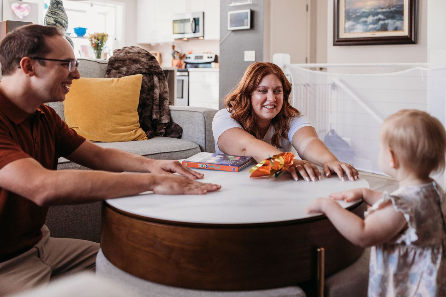People playing a board game at a kitchen table enjoy quality family time together.