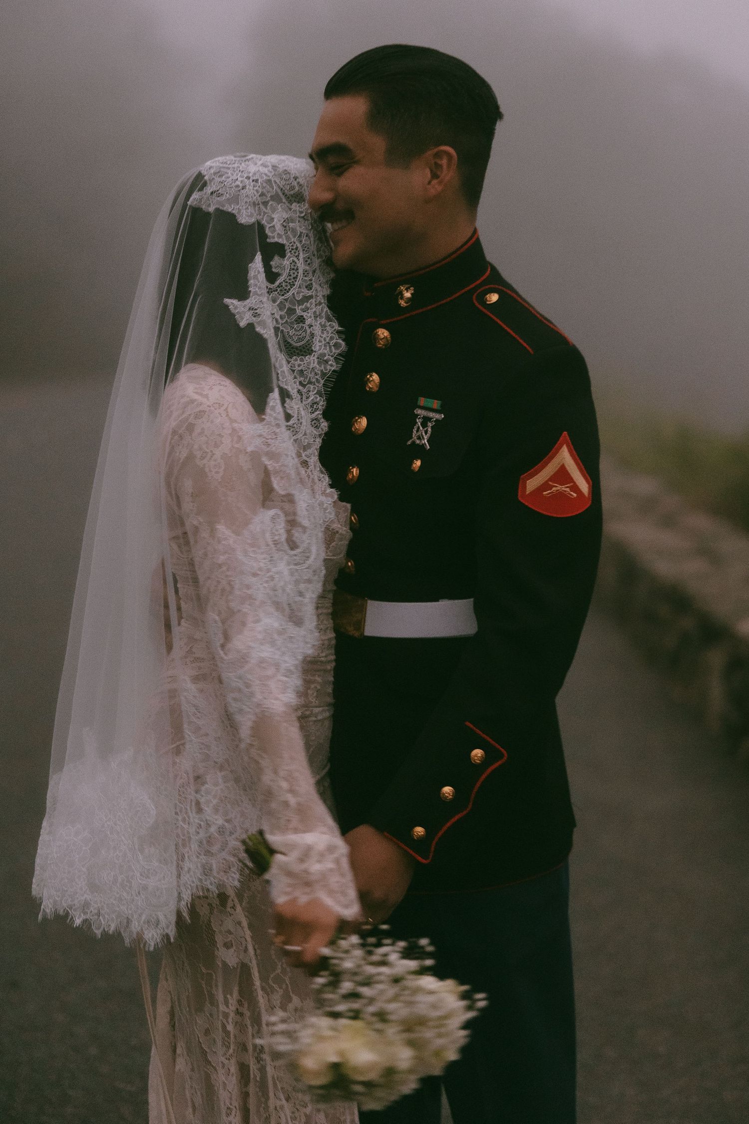Intimate wedding couple portraits in moody lighting and mist.
