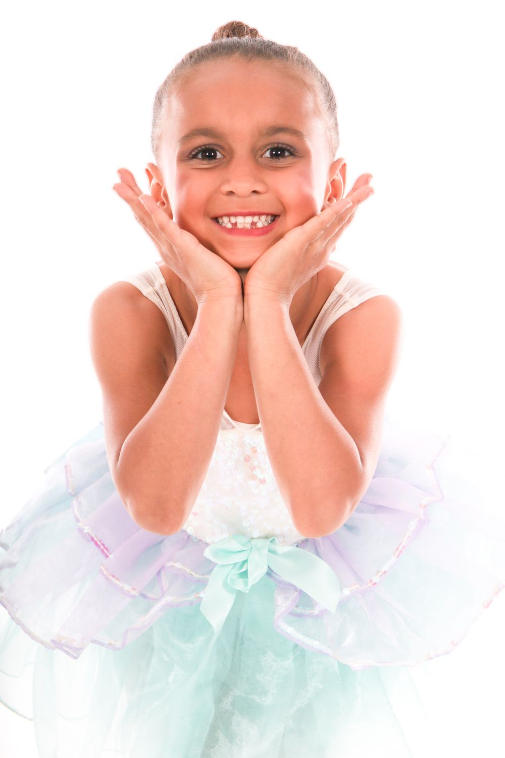 Dancer in mint tulle dress shows playful expressions against white background.