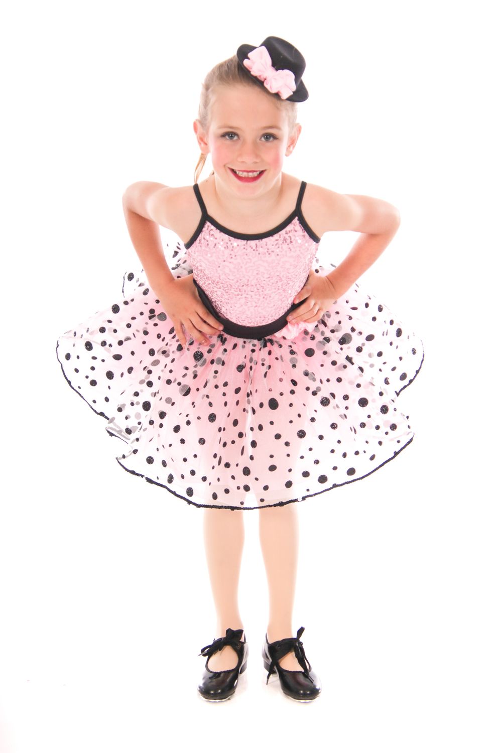 Dance performer in polka dot tutu dress shown from different angles.