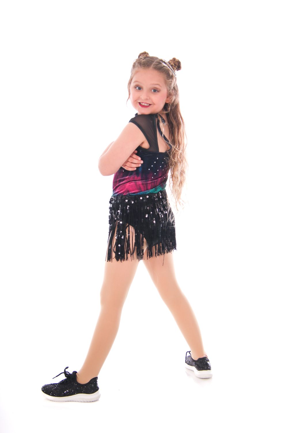 Dancer in black fringe costume demonstrates dynamic dance moves.