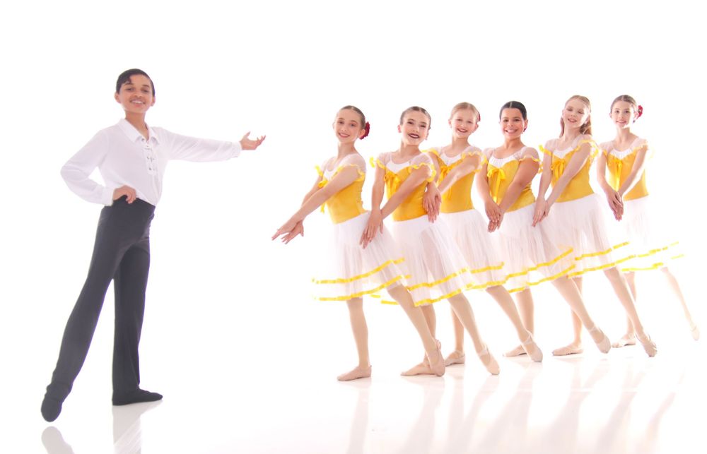 Dance group performing coordinated movements in matching yellow costumes.