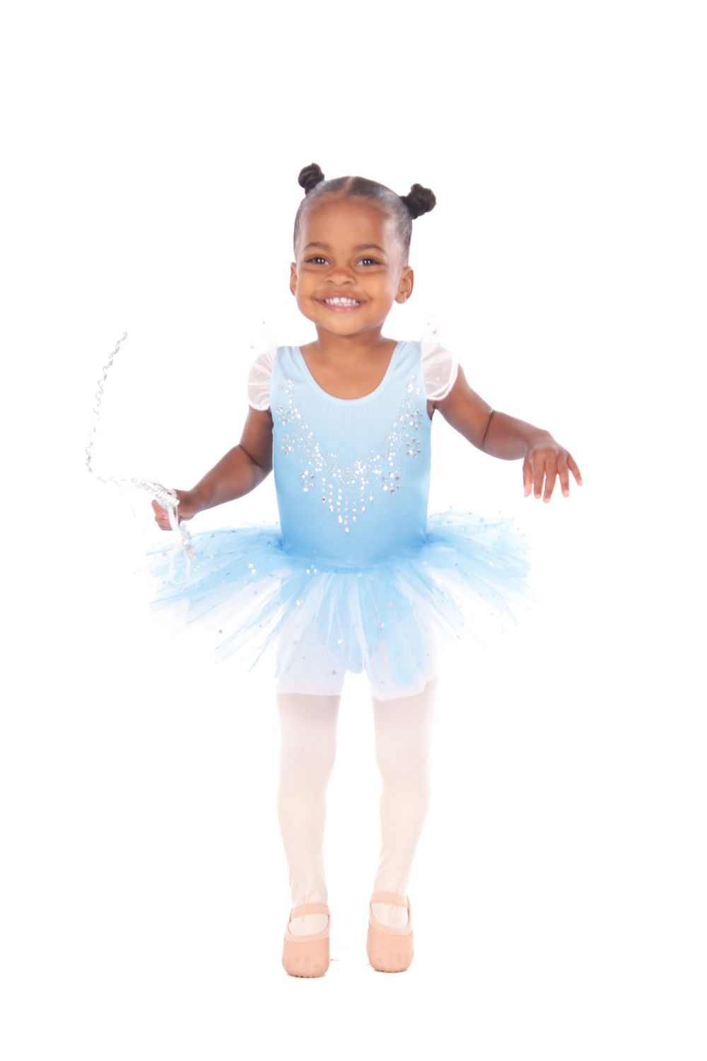 Young dancer in light blue tutu twirls gracefully against white backdrop.