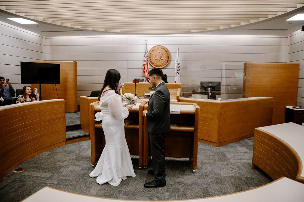 Five sequential photos showing a court proceeding inside a wood-paneled courtroom with a judge's bench and gallery seating area.