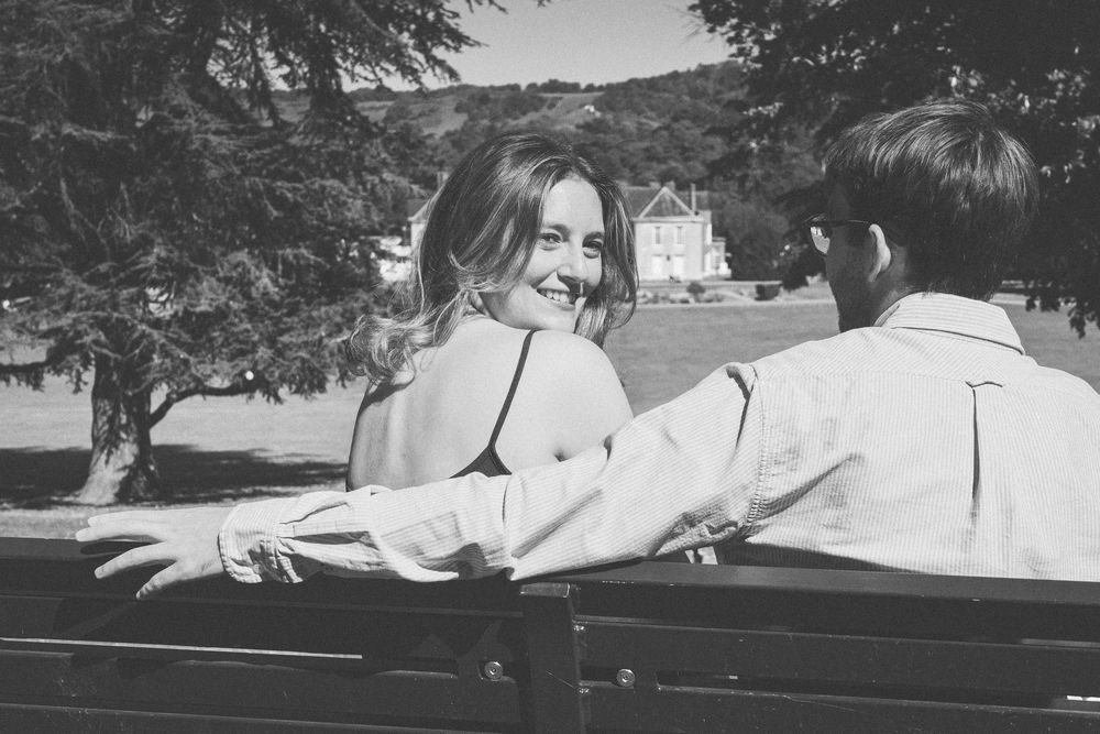Vintage black and white photographs of people enjoying a summer day in a classic convertible car.