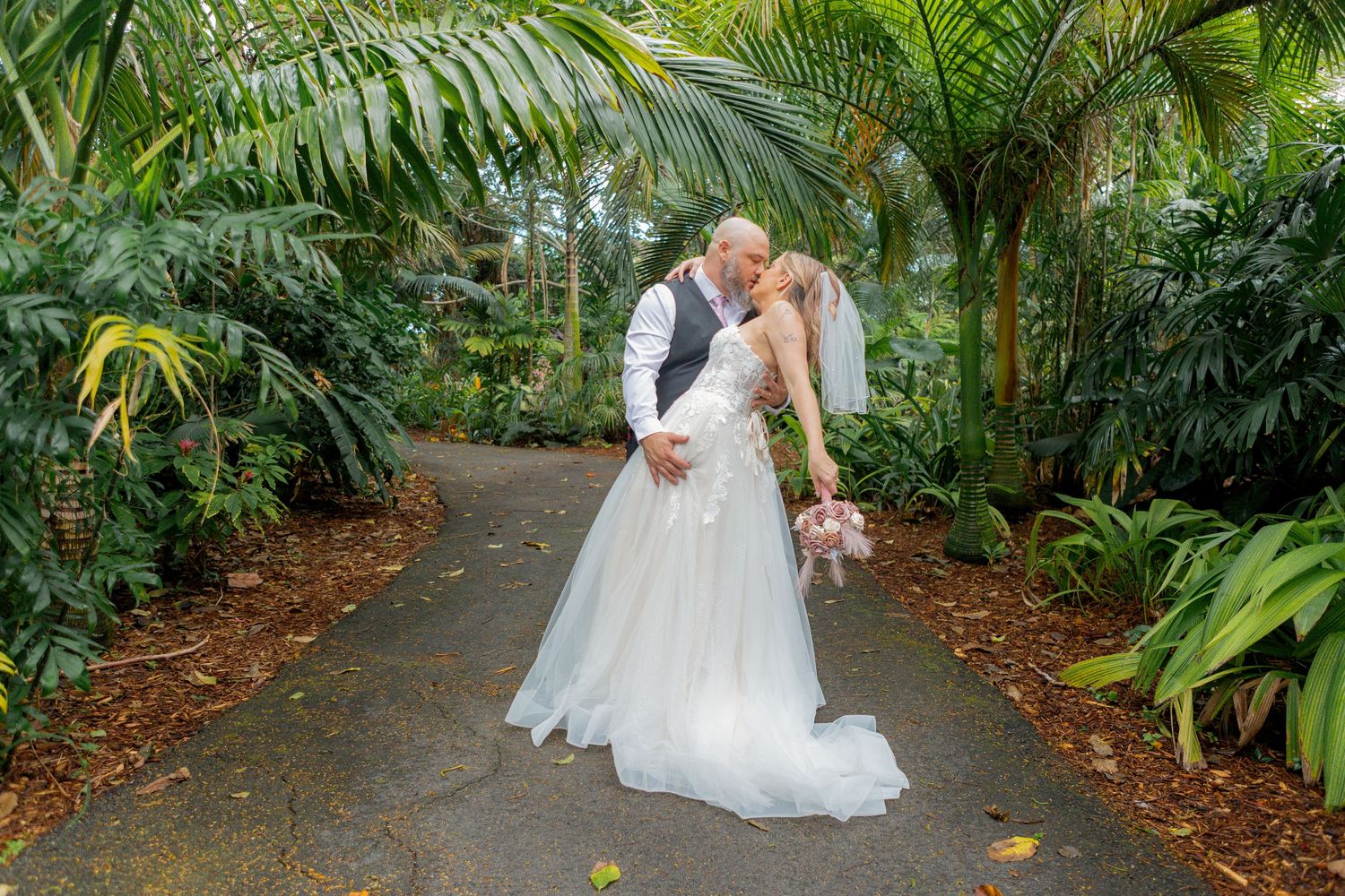 Groom dip kissing bride at the Arboretum in Deerfield Beach