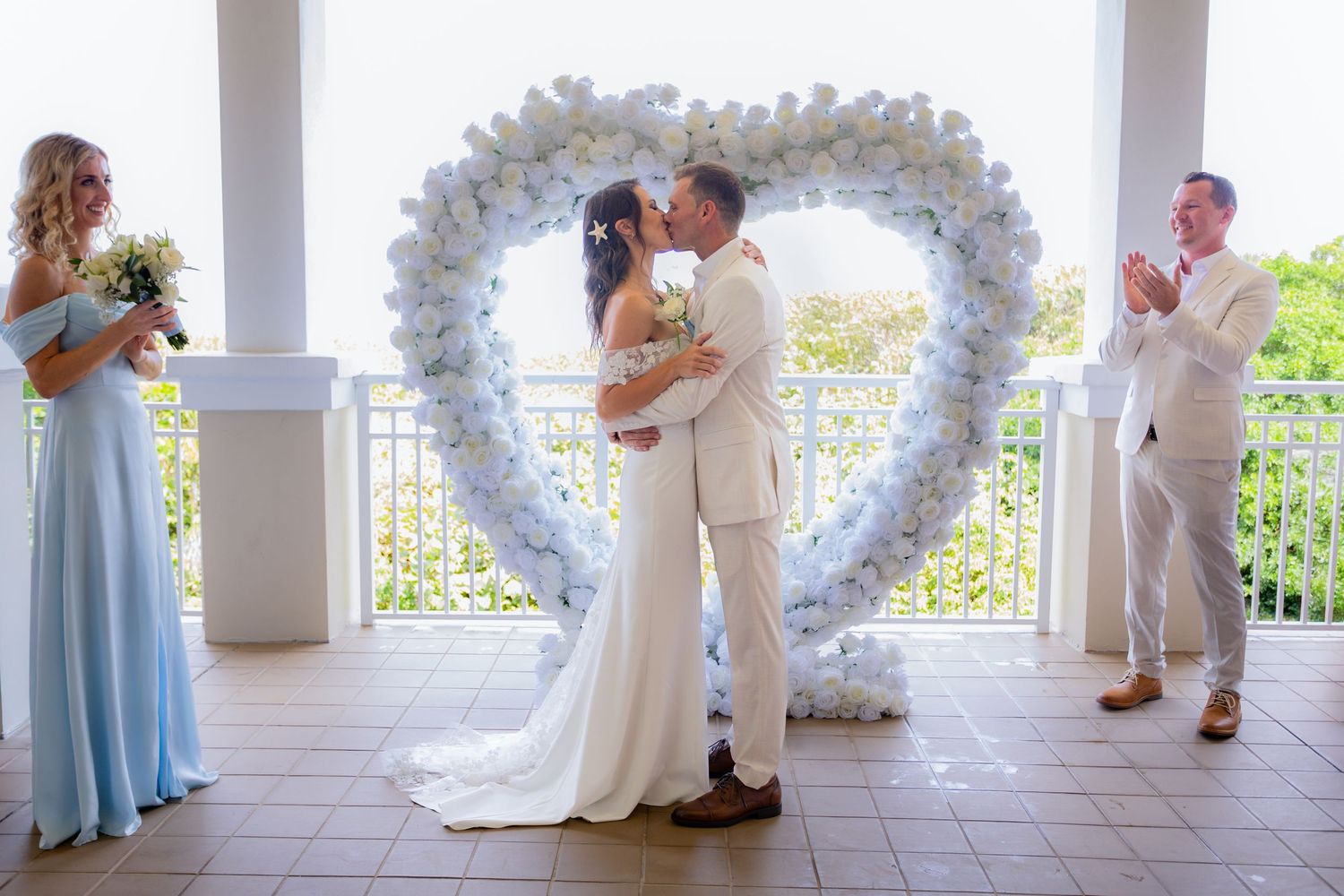 Bride and groom's first kiss at palm shores clubhouse