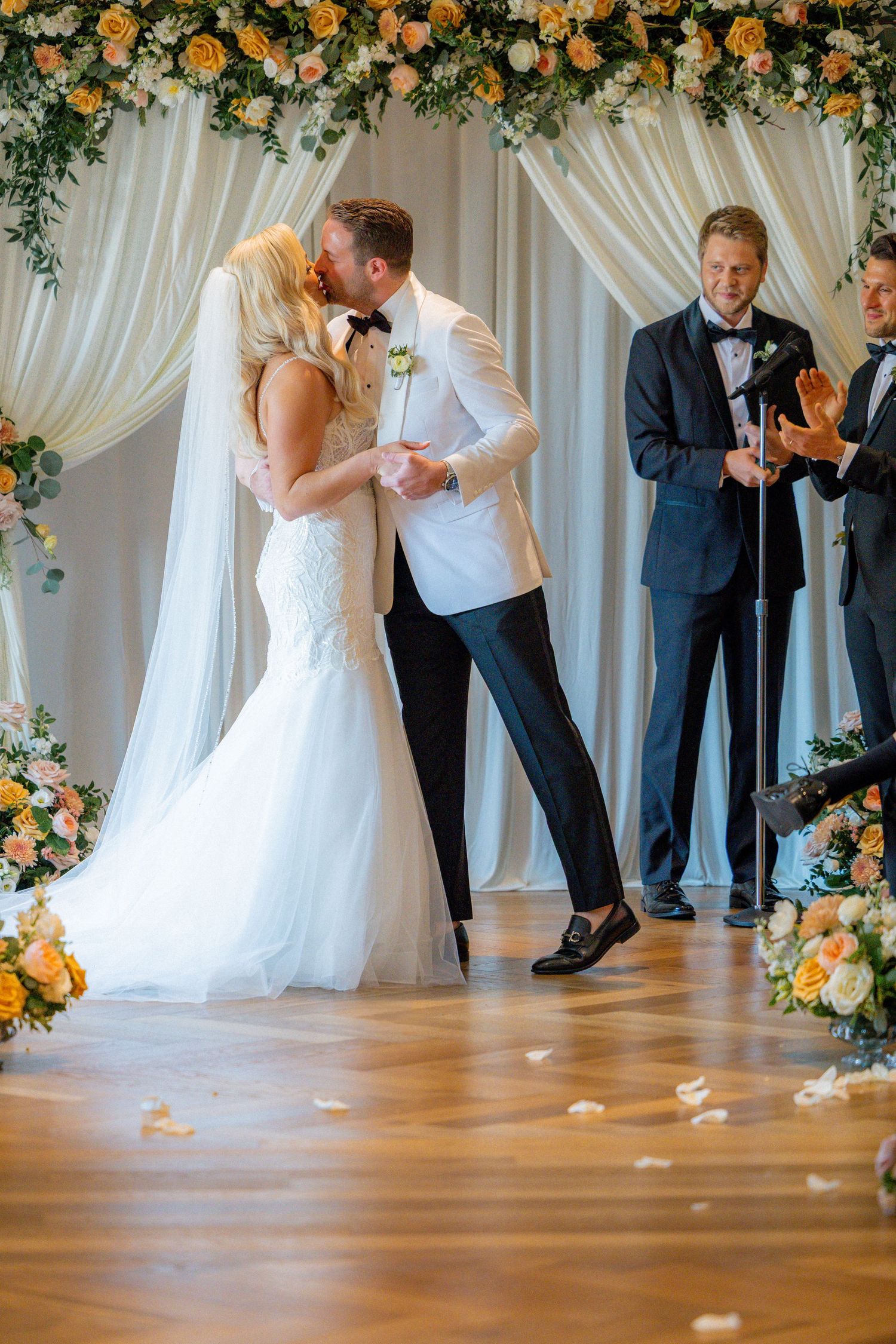 Bride and groom kissing at Book Tower in Michigan for first kiss