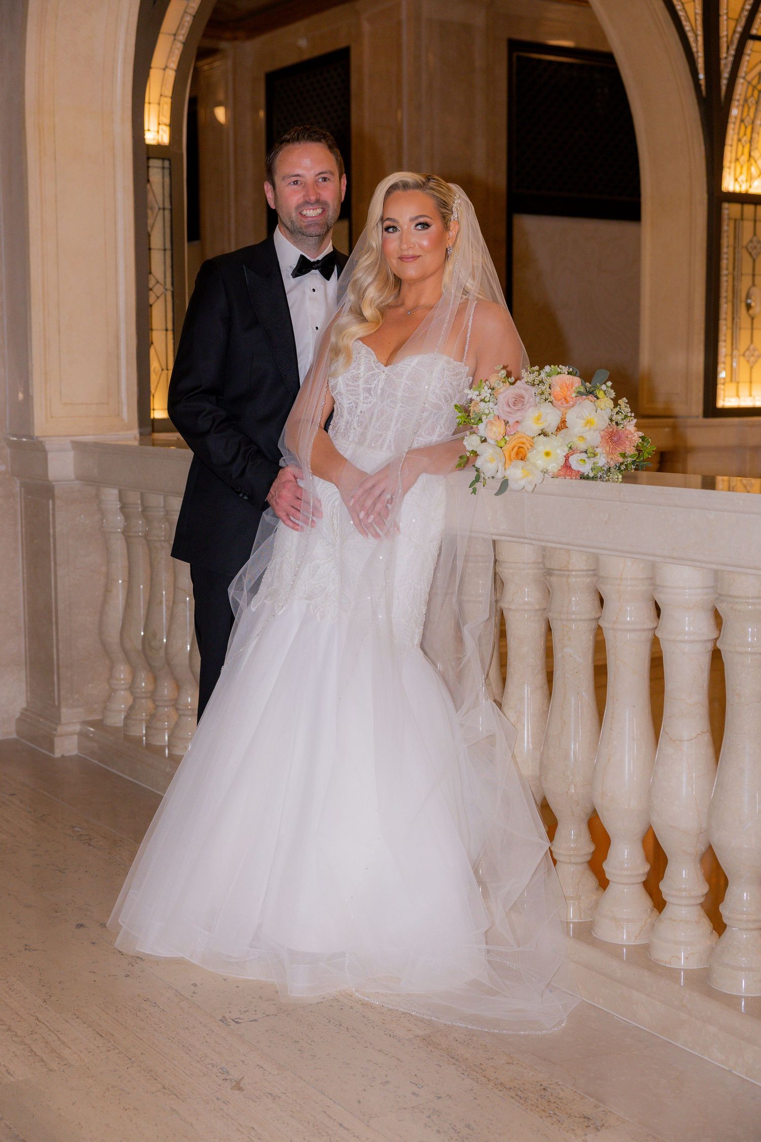Bride and groom on balcony of Book Tower in michigan