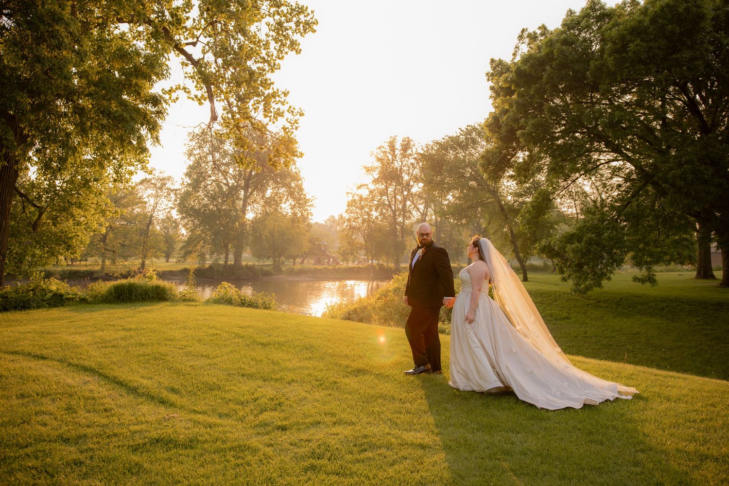 Bride and groom walking during sunset in midtown michigan