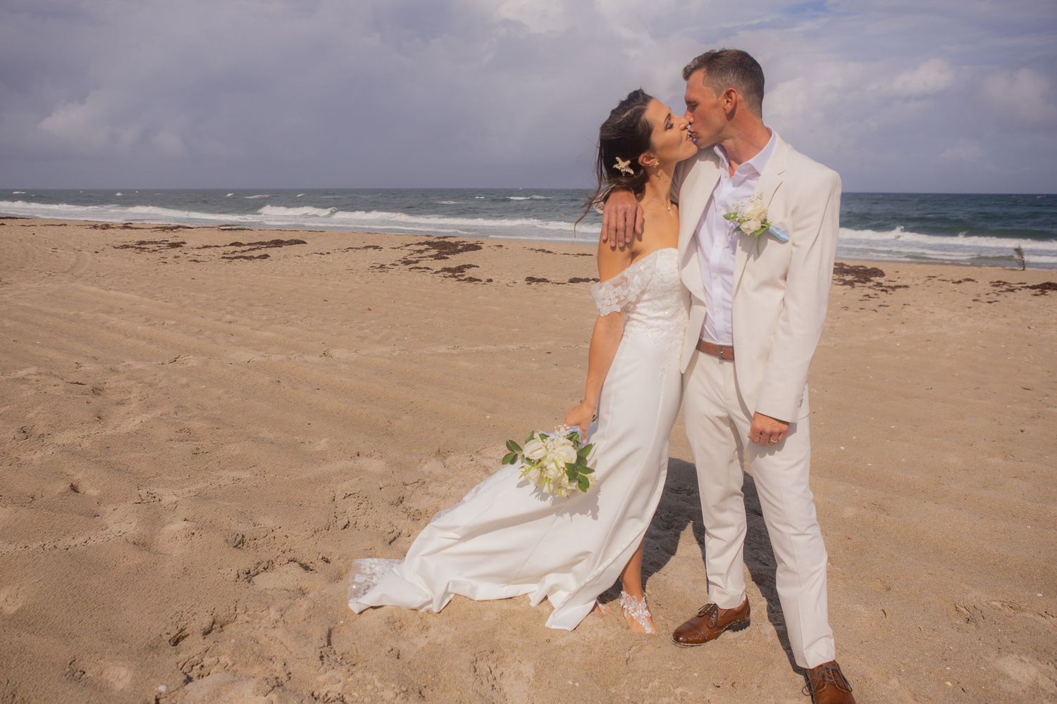Bride and groom kissing for portraits in Palm Beach