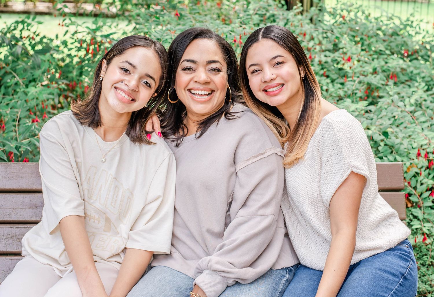 Friends laughing together during a sunny outdoor photo session.