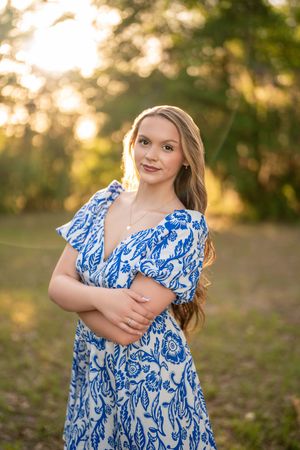 High school senior smiling in a wildflower field. Senior photographer serving Northeast Florida & Southeast Georgia.