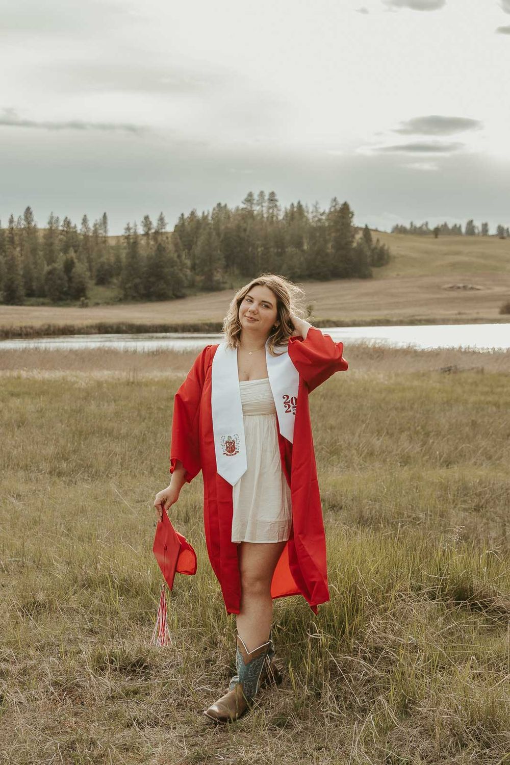 Graduation portraits in natural light with scenic countryside background. Cap and gown photo session for senior girl near Spokane WA