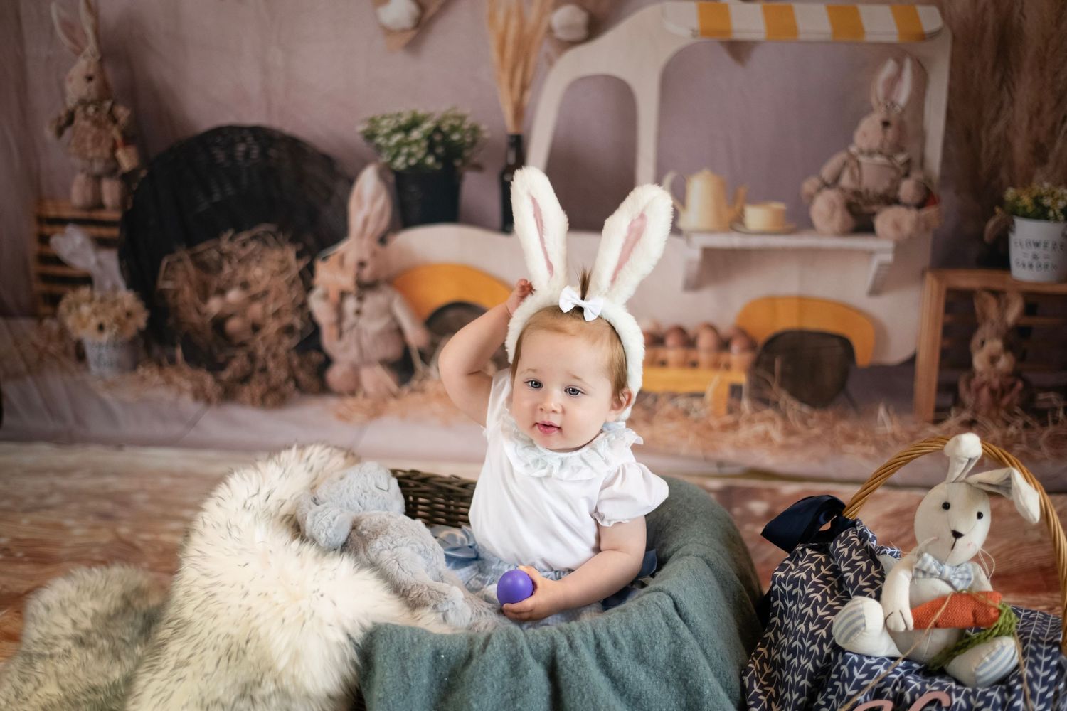 White bunny ears and springtime decor create a cozy Easter scene with plush toys and rustic elements.