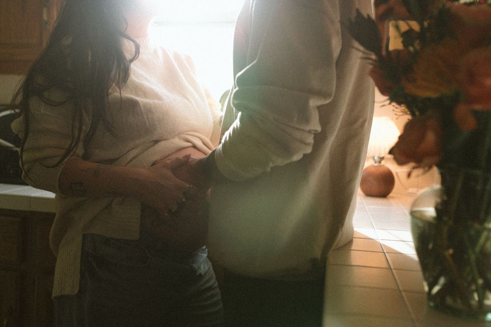 A series of blurred images showing hands and movement in warm lighting conditions.
