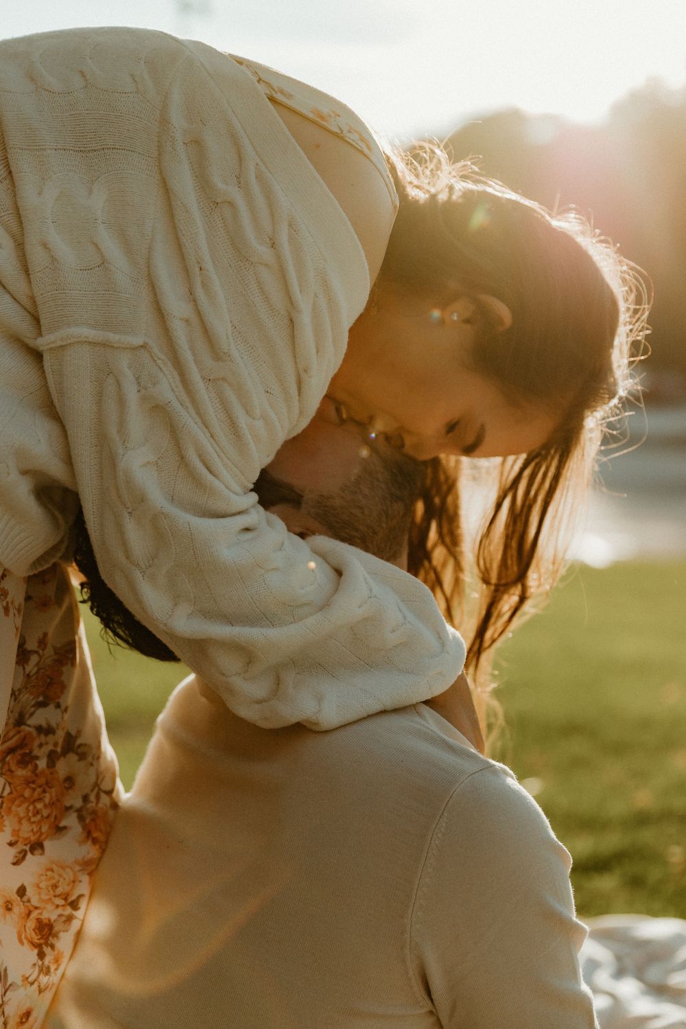 A romantic sunset portrait capturing an intimate moment between two people.