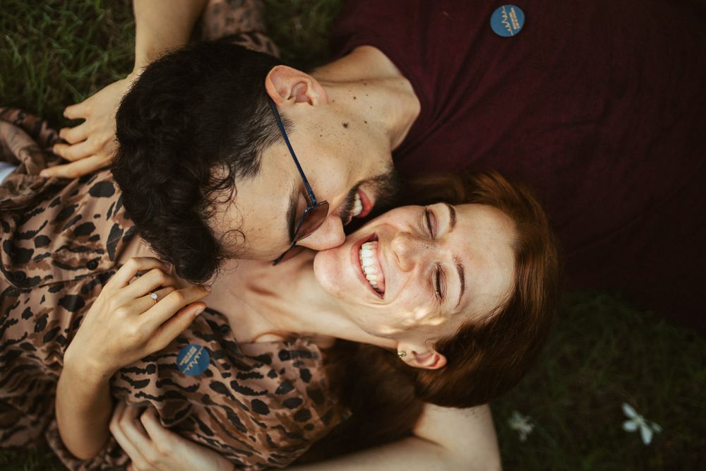 Intimate romantic photoshoot with dark moody lighting and close-up poses.