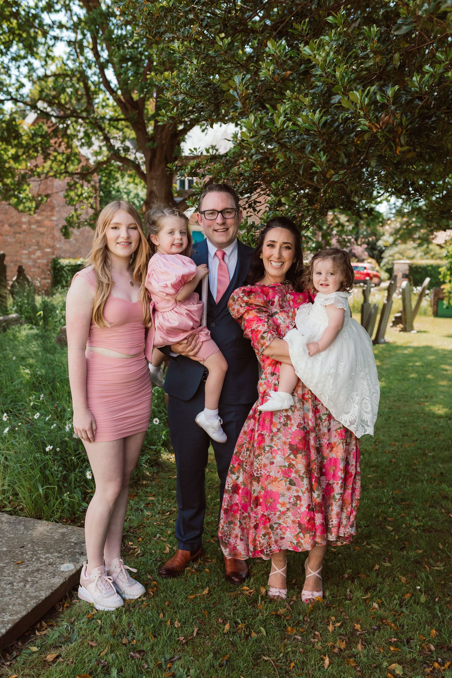 Outdoor family gathering under trees wearing pink and floral dresses. Photographer. Hull. East Yorkshire. Photography