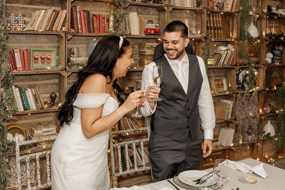 A couple shares romantic moments in a rustic indoor setting with wooden bookshelves and warm lighting.