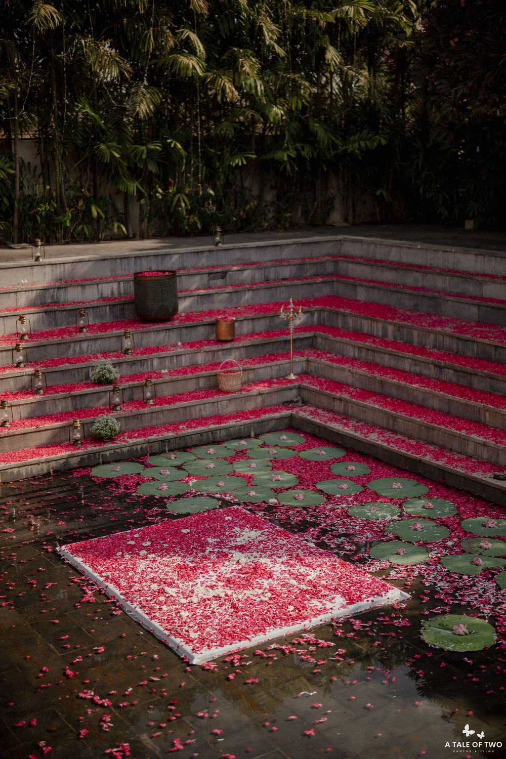 Tiered garden pool filled with pink rose petals and lily pads creates a stunning geometric pattern.