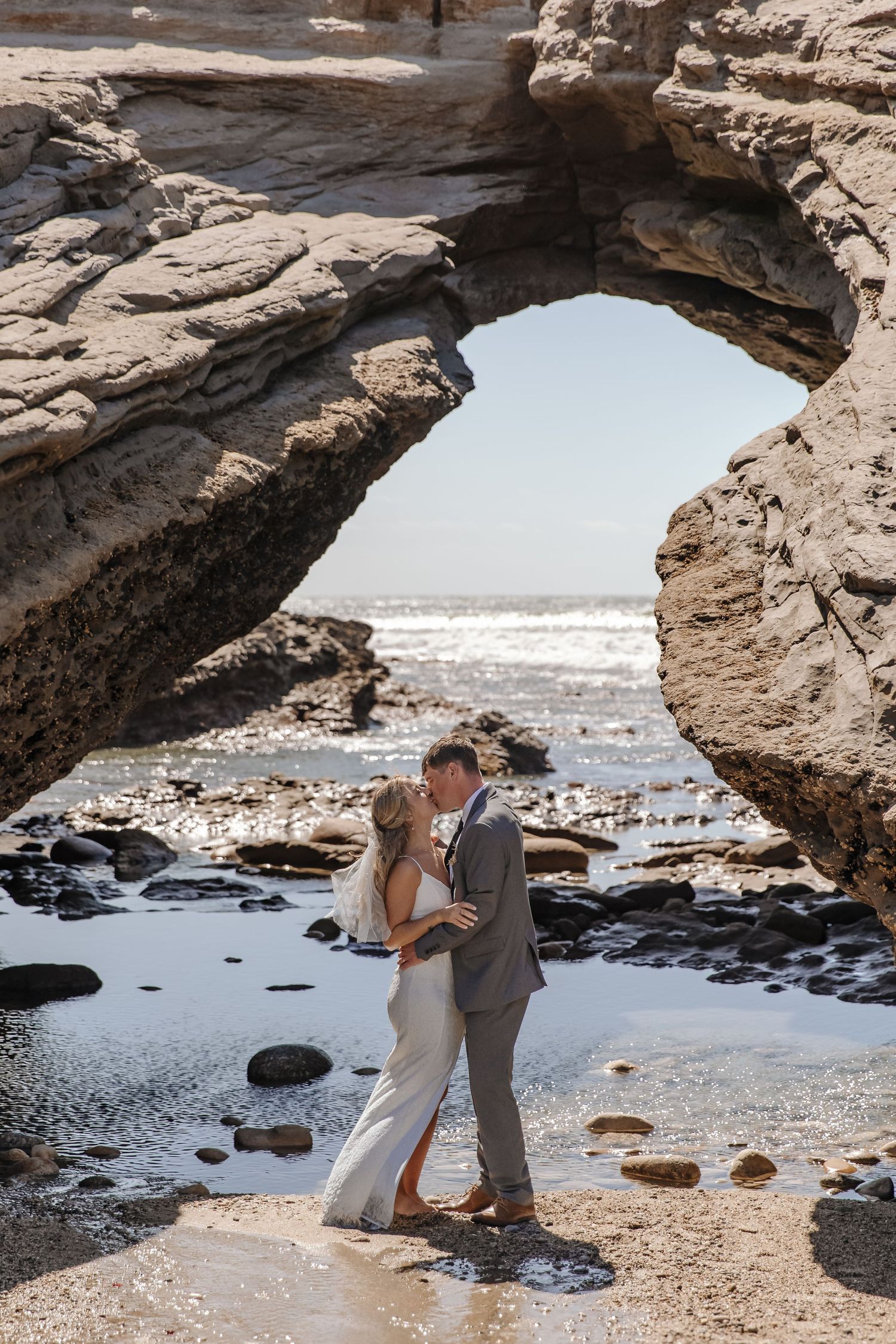 Newlyweds celebrating on a rugged West Coast NZ landscape