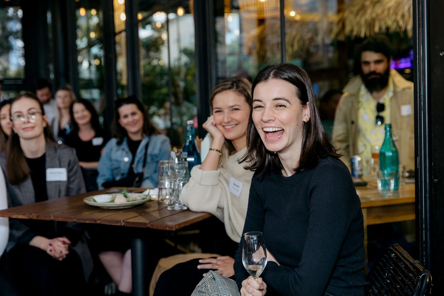 Guest at a corporate networking and panel discussion event laughing