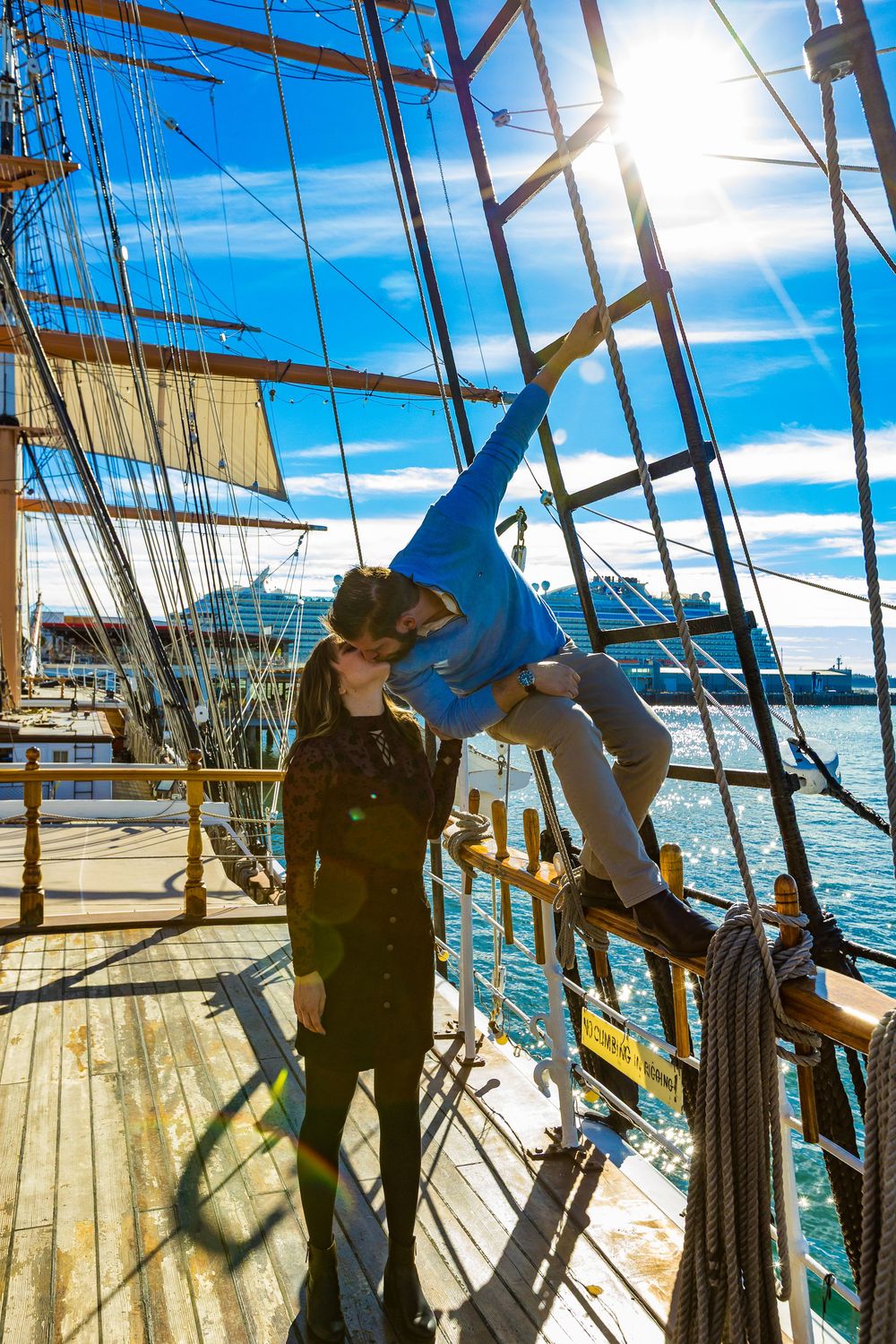 Silhouette of a couple on the deck of a tall ship at golden hour by Zeus Holbrook Wedding Photographer San Diego