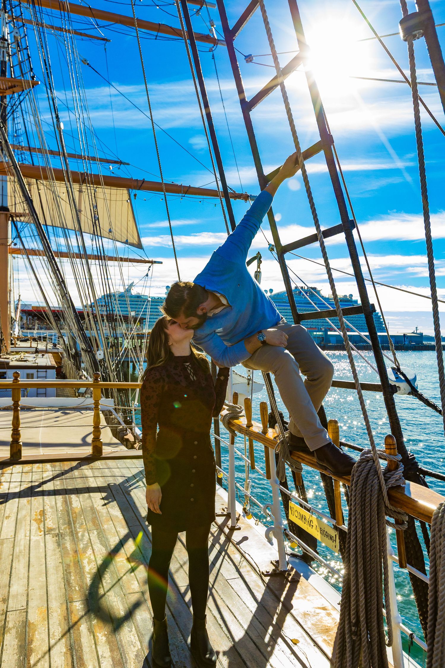 Silhouette of a couple on the deck of a tall ship at golden hour by Zeus Holbrook Wedding Photographer San Diego