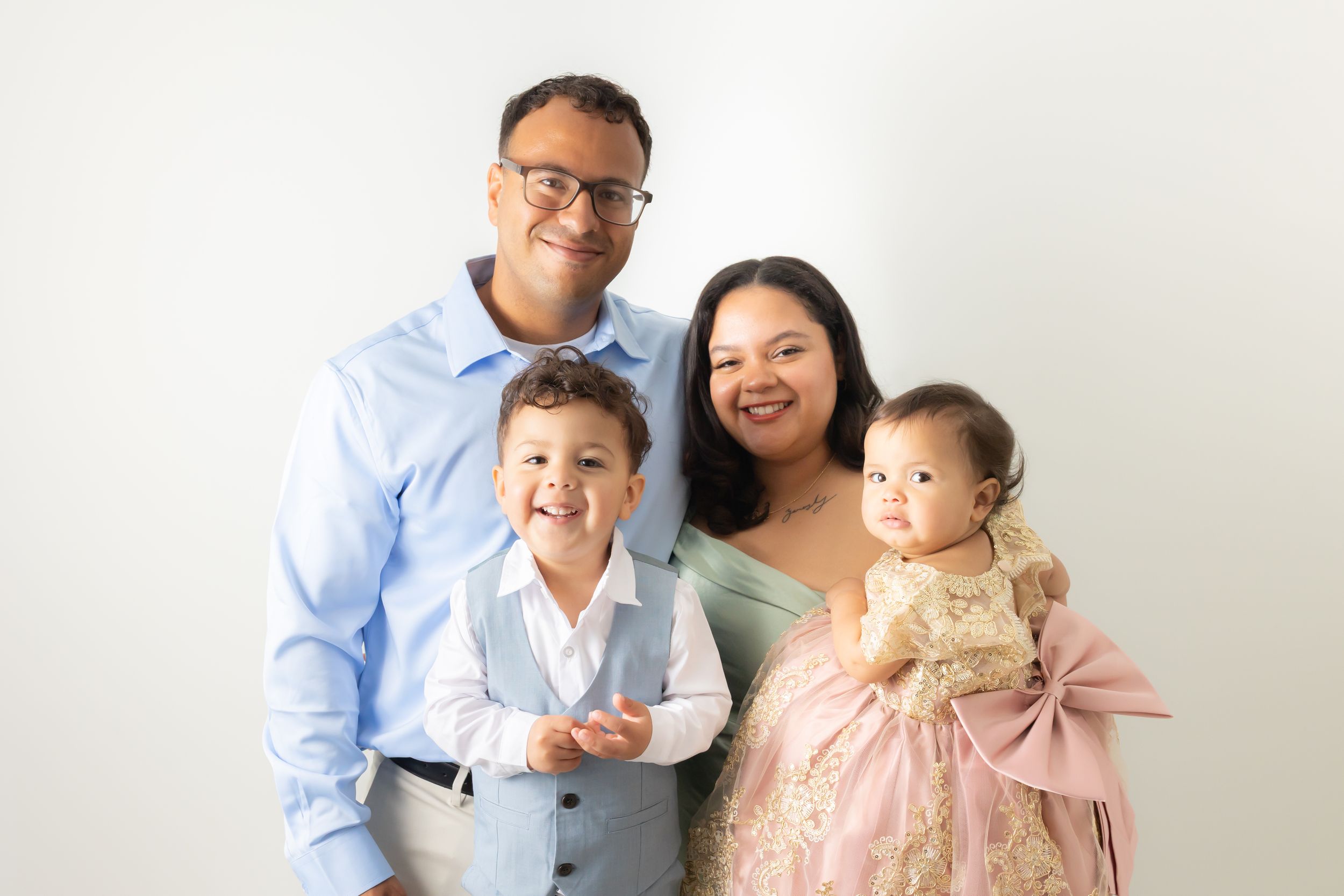 Classic studio portrait of a mother and father photographed on a clean backdrop for family wall art in Swansboro, NC photography studio