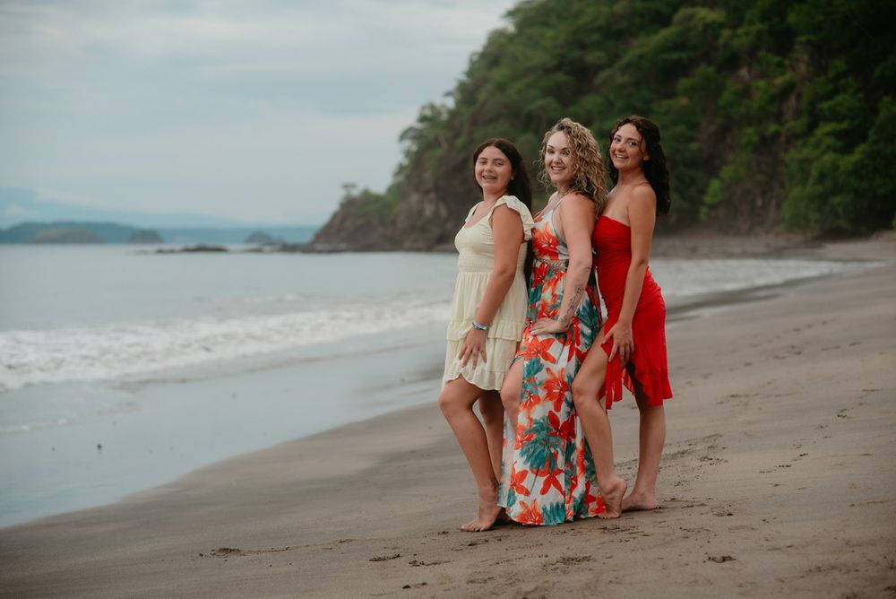 A group sits together on a beach at sunset creating a peaceful coastal scene.