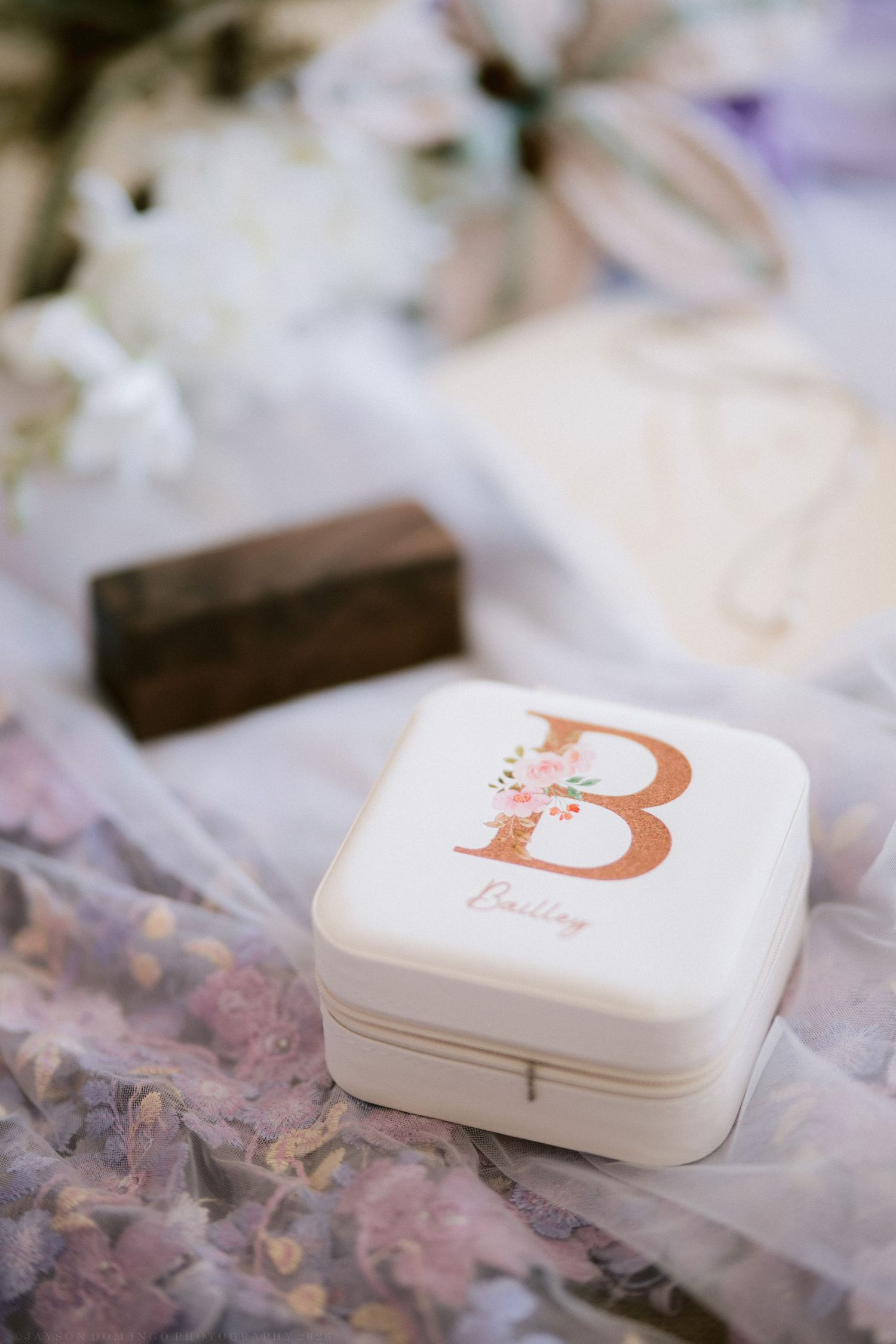 Personalized white jewelry box with floral letter B for Bailley displayed on a floral wedding veil.