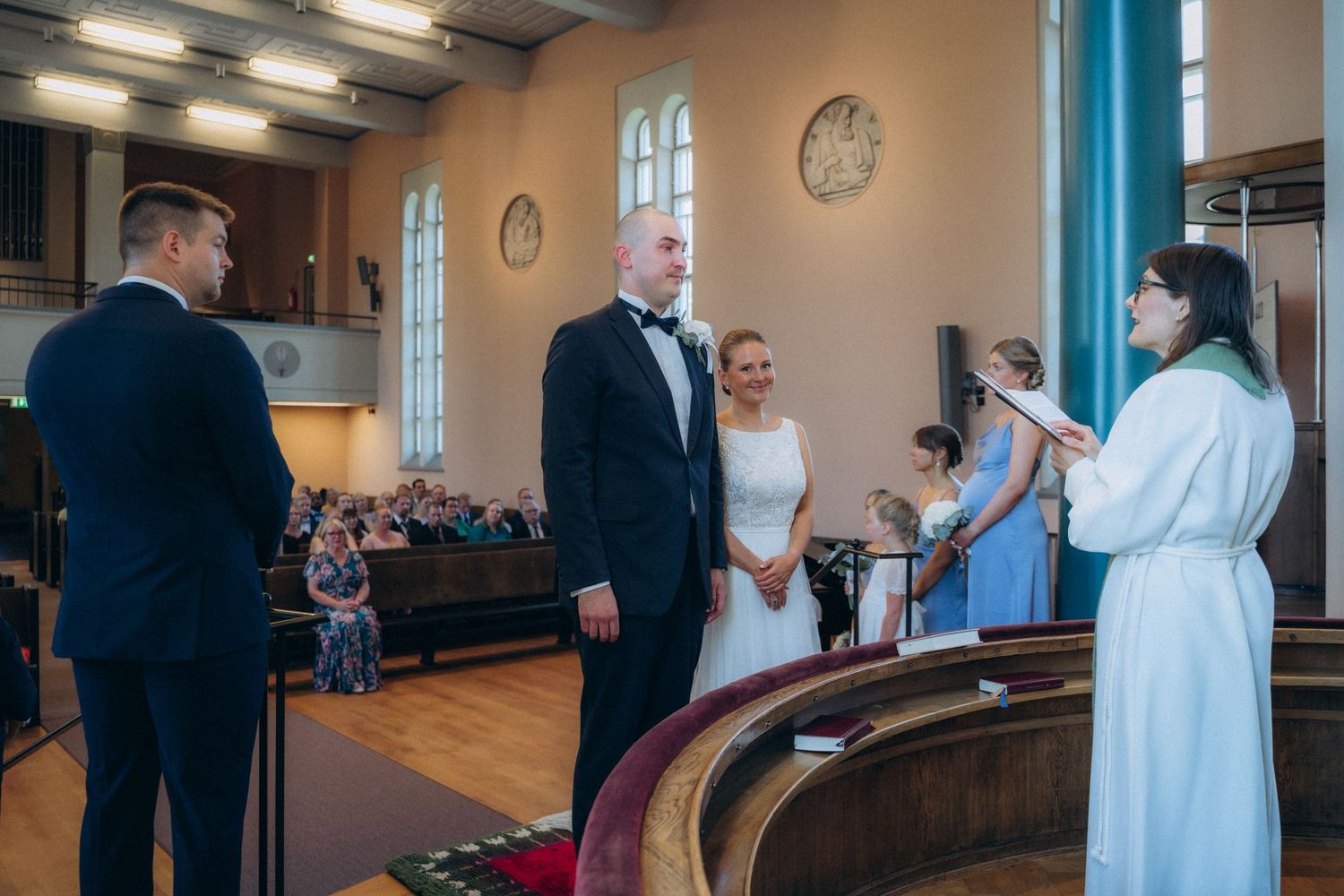 wedding ceremony inside church Töölön kirkko bride and groom exchanging vows cinematic documentary wedding photography Helsinki Finland
