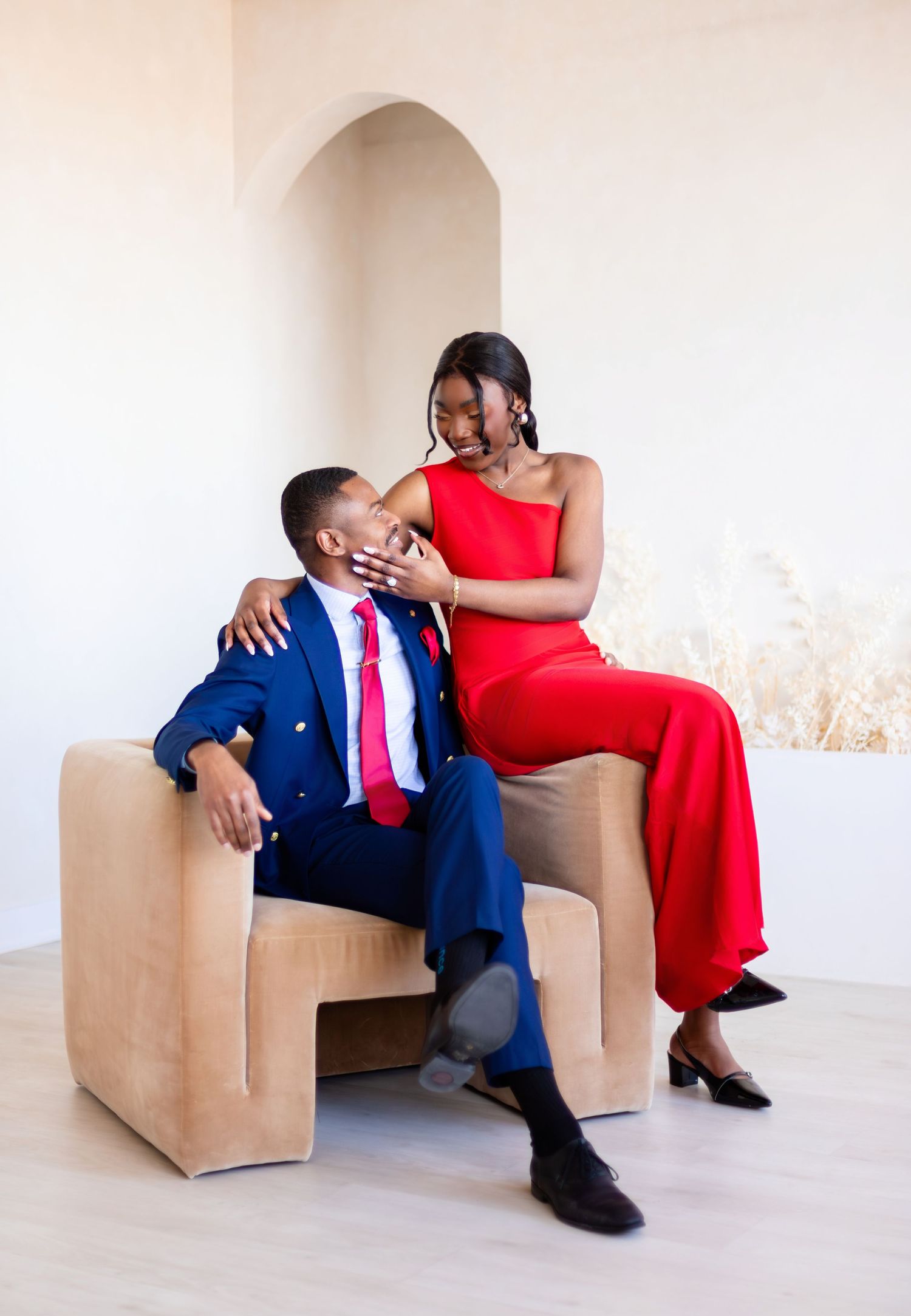 A couple in formal attire poses intimately across four artistic portrait shots in a minimalist setting.