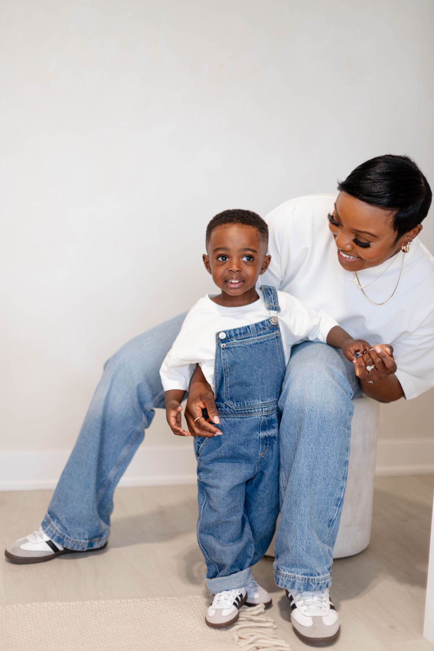 A series of cropped photos showing matching denim jeans and white sneakers worn by a parent and child.