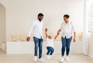 A series of photos showing people playing and interacting with a small white dog in a bright minimalist room.