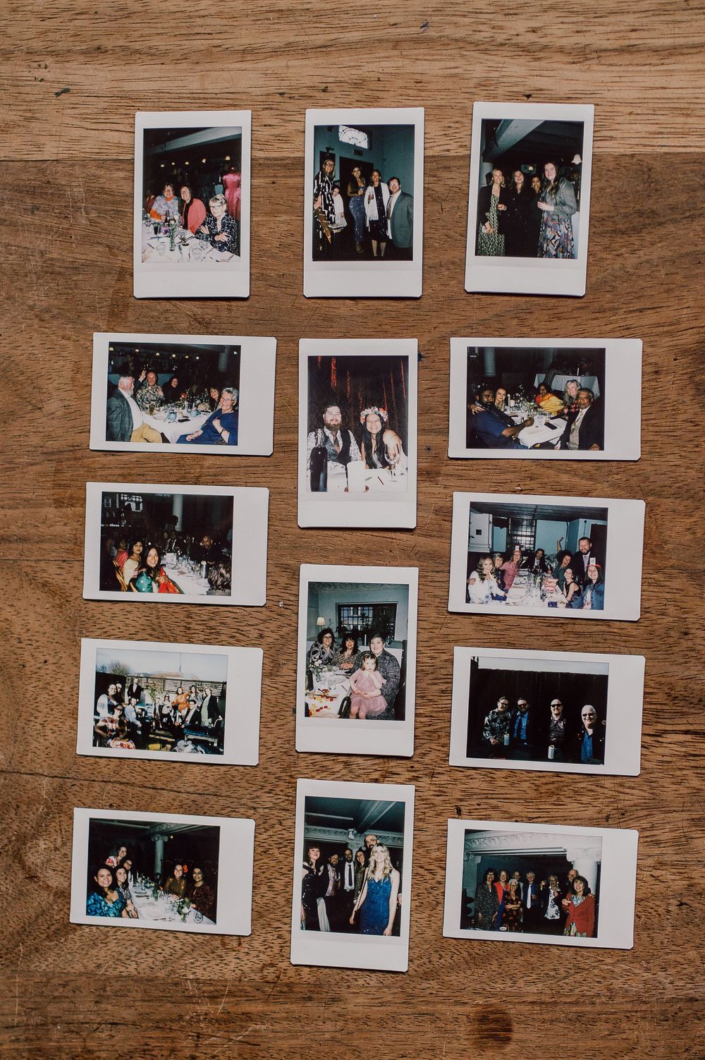 Collection of polaroid photographs arranged on wooden surface showing party or celebration memories.