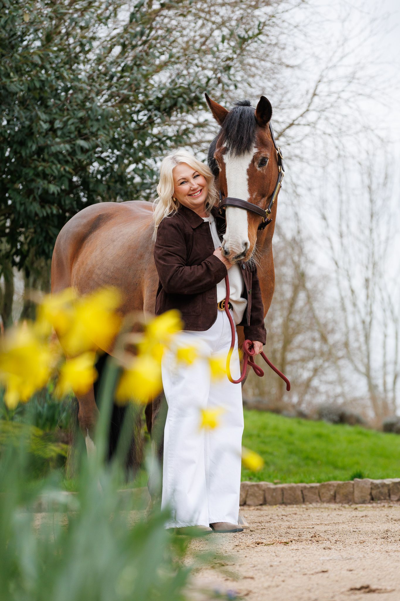 A series of photos showing a person in a white polka dot shirt with a black horse in a golden autumn field.