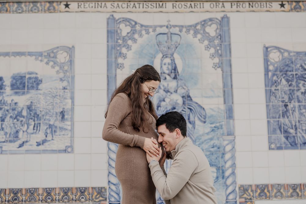 A tender moment captured against a backdrop of traditional Portuguese blue and white azulejo tiles.