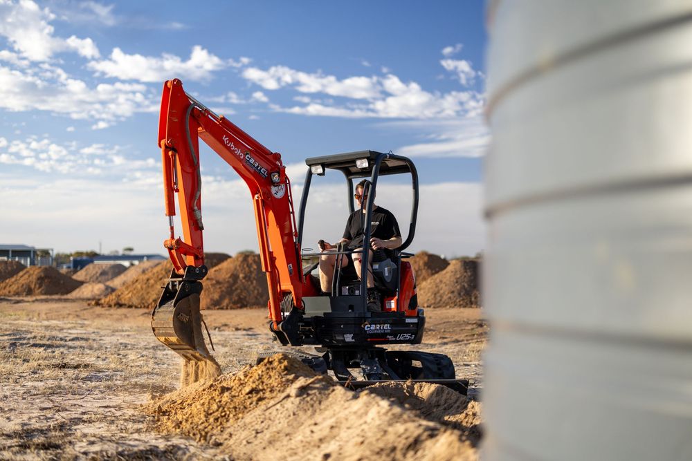 Mini excavator moving dirt on construction site in Murray Bridge