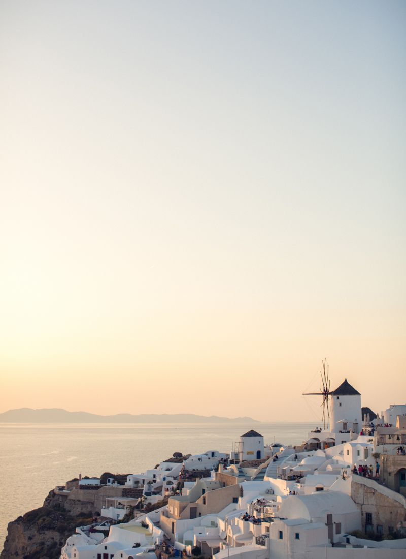 White architecture of Santorini with windmill overlooking the Aegean Sea