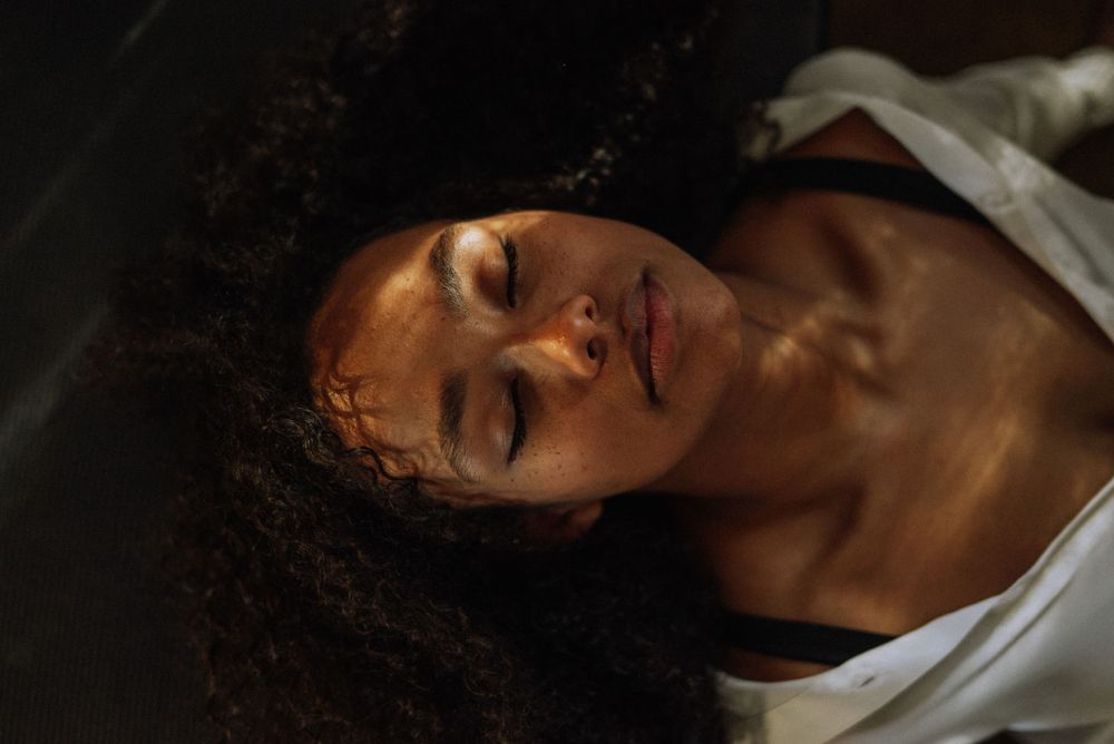 Intimate portrait with soft natural lighting and deep shadows creating mood.