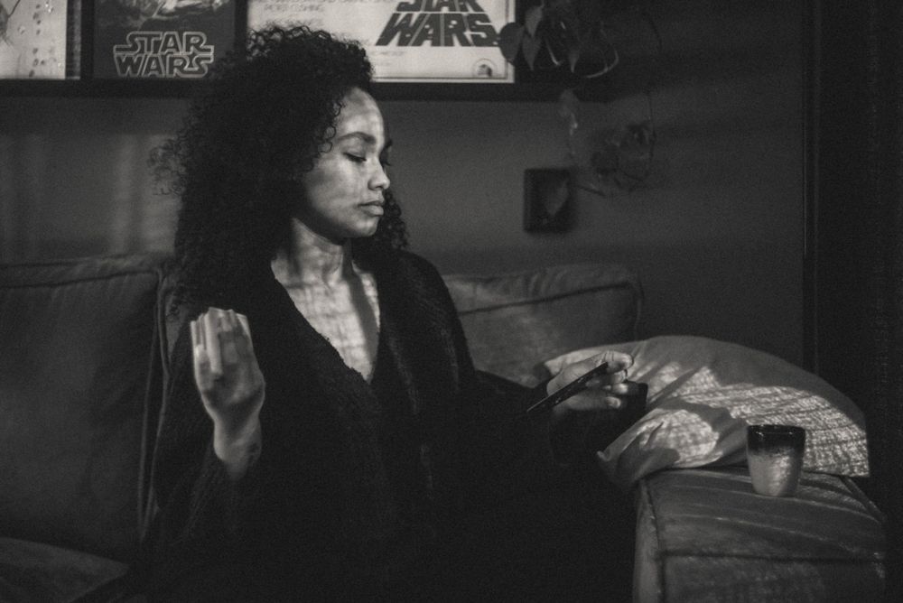 Person lounging on couch with Star Wars posters visible in background.
