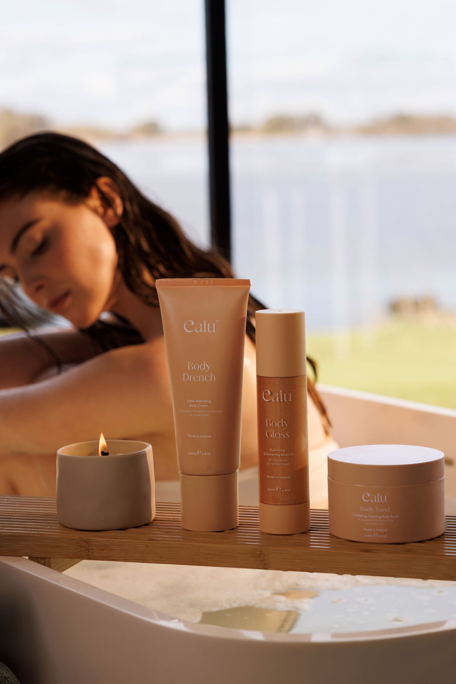 Collection of Oulu beauty products displayed on table with waterfront view.